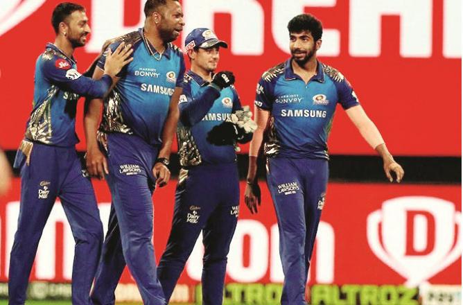 Mumbai Indians players happily return to the pavilion after the victory over Bangalore.Picture :PTI 