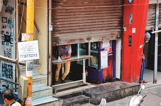 The shutters of a shop and a hotel are half open.Picture: Syed Samir Abidi