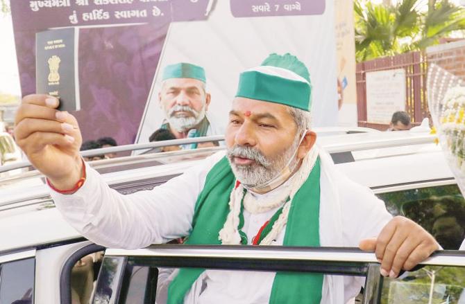 Rakesh Tikit showing his passport outside Sabarmati Ashram. Picture: PTI