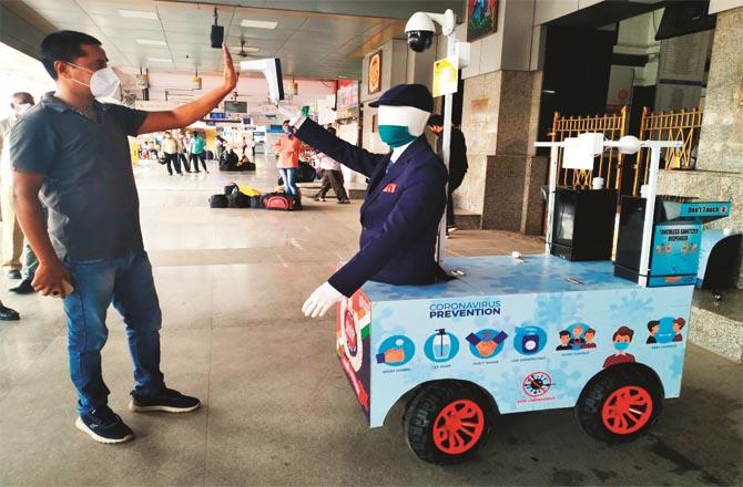 A robot named Captain Arjun checks a passenger`s body temperature at a train station. (File photo)