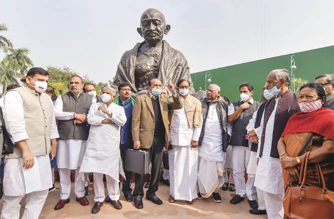 Opposition members protest near the statue of Mahatma Gandhi in the Parliament premises. (PTI)