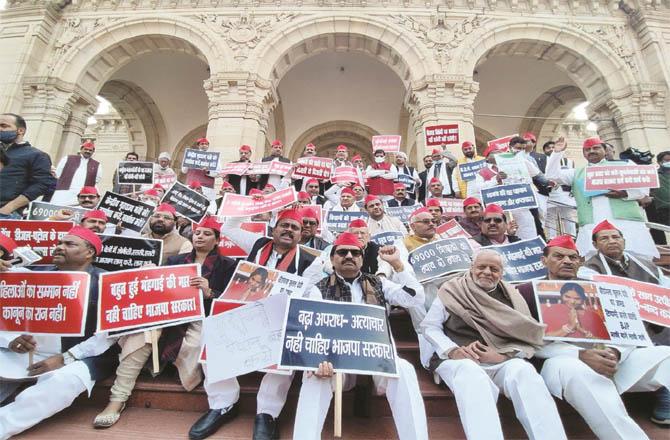 Opposition members in Lucknow sit on a sit-in outside the House on the first day of the Assembly session.