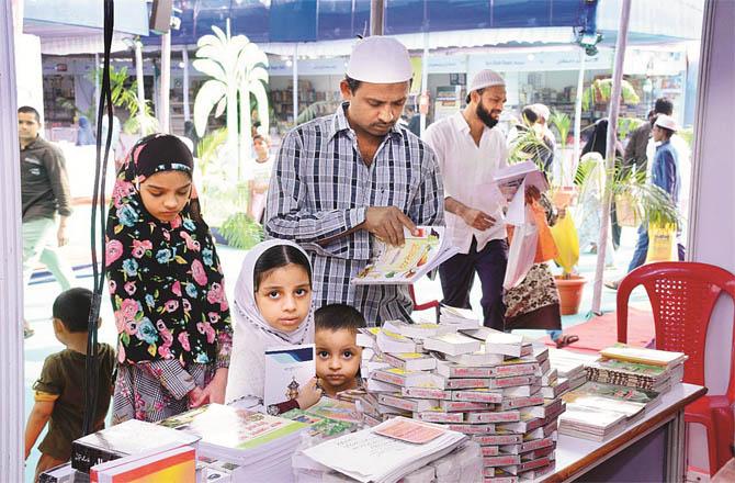 Book lovers turn the pages at the book stall at Malegaon Urdu Book Fair