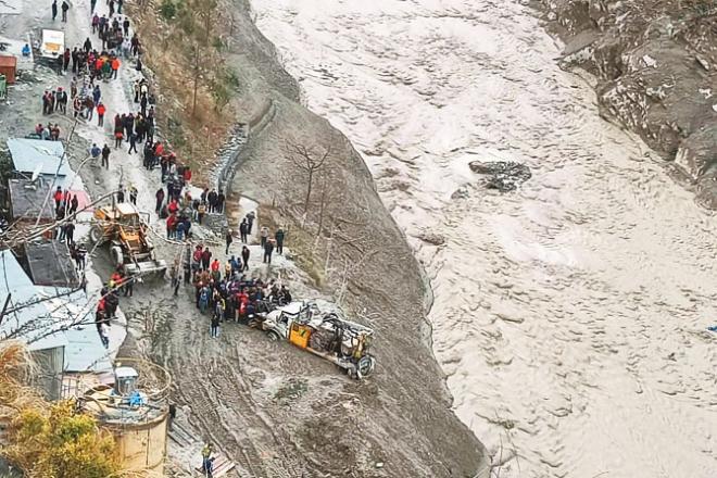 Rescue workers near the Dholi Ganga hydroelectric station are seen rescuing trapped people.Picture :PTI