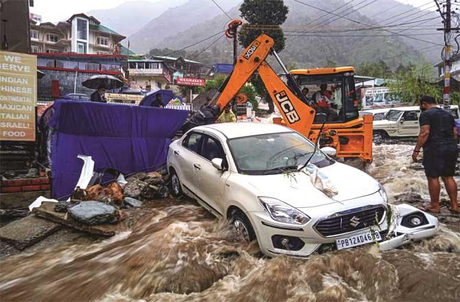 Houses and vehicles have been severely damaged in a flood-like situation after the cloudburst in Dharamshala.Picture:PTI