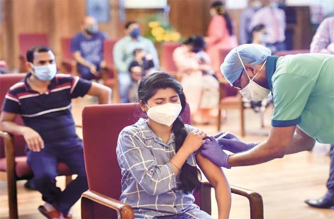 A medical worker administers the corona vaccine to a girl in Bangalore.Picture:PTI