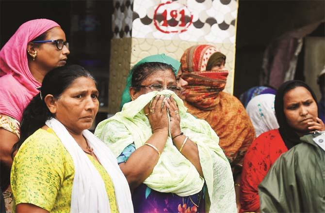 Relatives, friends and neighbors of the victims could not control their emotions after the accident in malwani.Picture:PTI