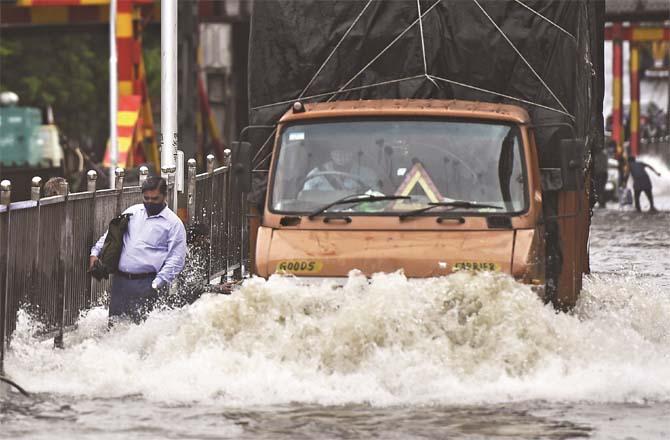 Train and bus service affected due to accumulation of water on road and railway track.Picture:PTI