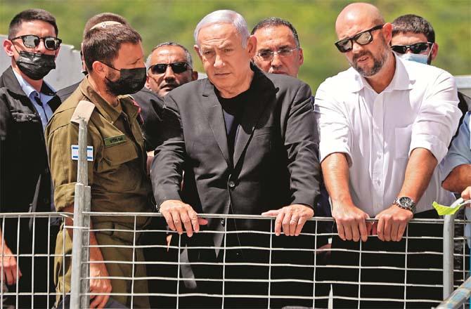 Netanyahu inspects the crash site with officials.Picture:PTI