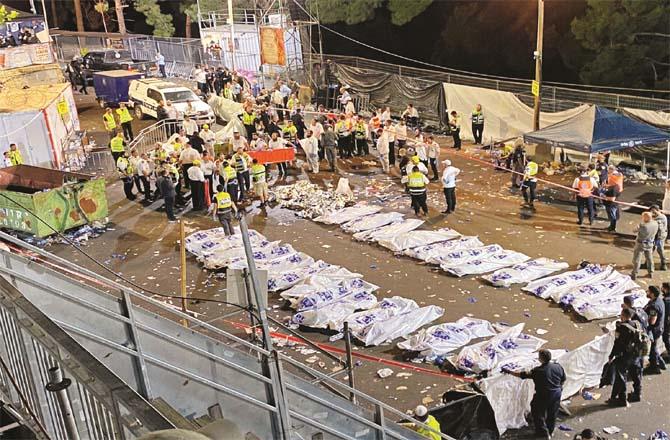 Bodies piled up after the stampede, while two people can be seen crying on the leftPicture:PTI