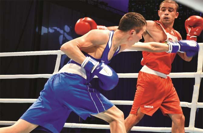 Boxer Amit Panghal stops opponent`s punch in Asian Championship semifinals.Picture:PTI