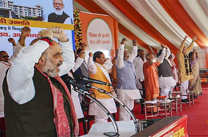 Amit Shah chanting slogans while addressing a public meeting in Azamgarh. (PTI)