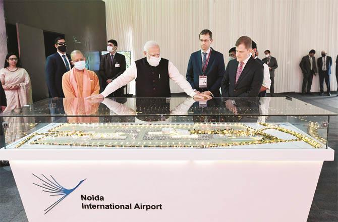 Prime Minister Modi inspecting the exhibition at Noida International Airport with Chief Minister Yogi. (PTI)