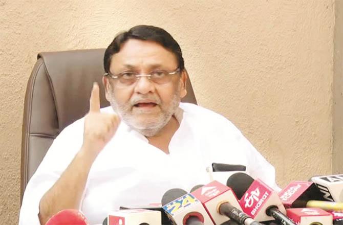 Nawab Malik addressing a press conference.