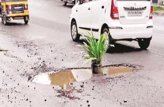 A pothole can be seen in the pit to save motorcyclists from an accident due to a pit on Dombivli Road.Picture:Inquilab