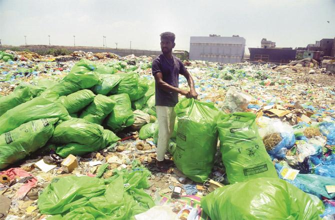 A man separates garbage at the Deonardumping Ground