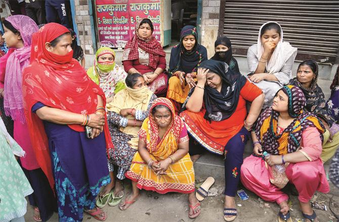 The women of the houses of the arrested youths in Jahangirpuri are sitting anxiously outside the police station. (Photo: PTI)
