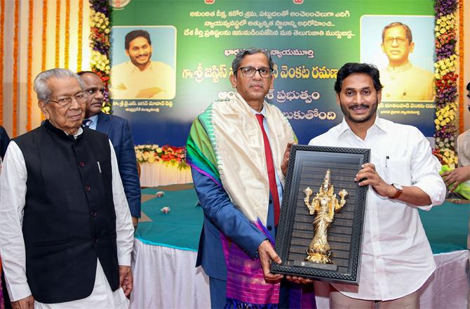 Chief Justice Jagan Mohan presenting Redemption to Chief Justice Ramana. (PTI)