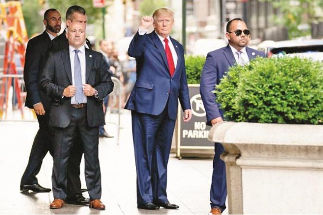 Former US President Donald Trump can be seen leaving Trump Tower with his security personnel..Picture:INN
