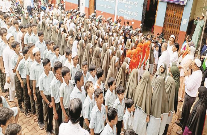 Students performing National Anthem at Maulana Azad School premises