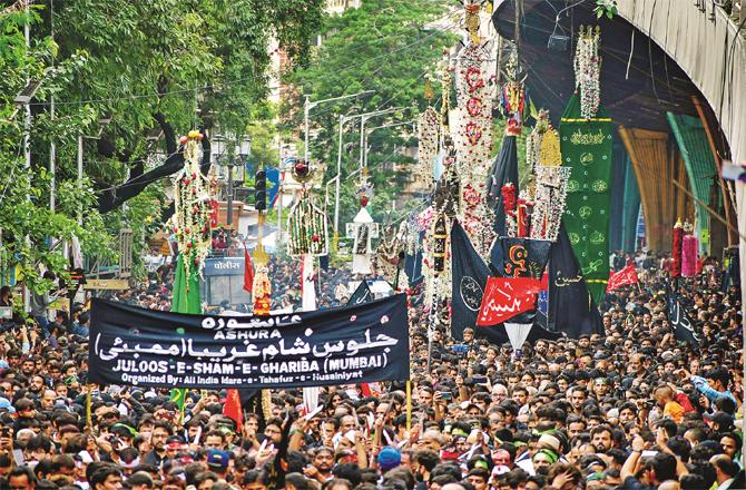 A large number of participants are seen in the Ashura procession from Bhandi Bazaar to Rahmatabad Cemetery. (PTI)