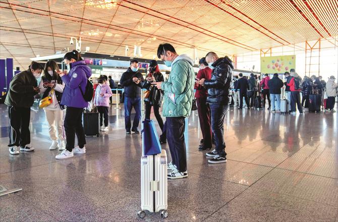Passengers are seen at an airport in Beijing. (AP/PTI)