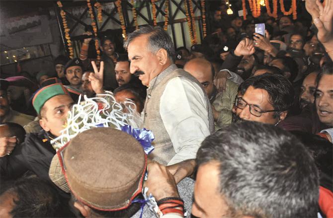 Himachal chief minister-designate Sukhwinder Singh Sukhu showing victory sign to his supporters. (PTI)