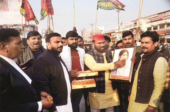 Samajwadi Party workers fondle the picture of Dimple Yadav who won the entire Lok Sabha seat by a landslide.