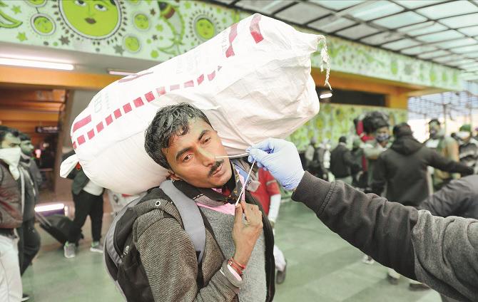 Health workers in Delhi take a sample of a person for testing..Picture:PTI