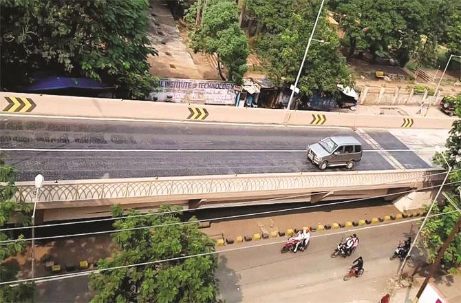 Pits are being filled with tar on Dr. PJ Abdul Kalam flyover.Picture:Inquilab