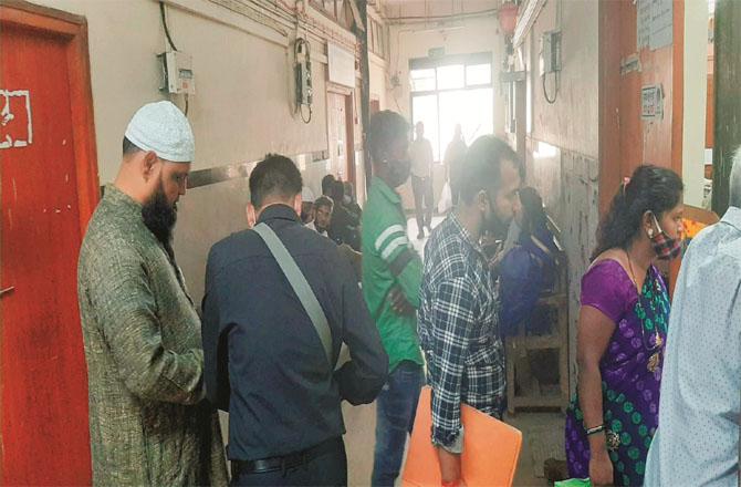 People can be seen queuing for birth certificates