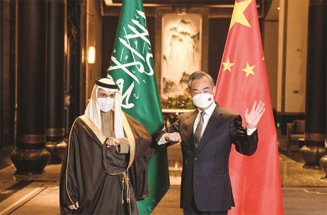 Wang Yi (right) welcoming Faisal bin Farhan (Photo: Agency)