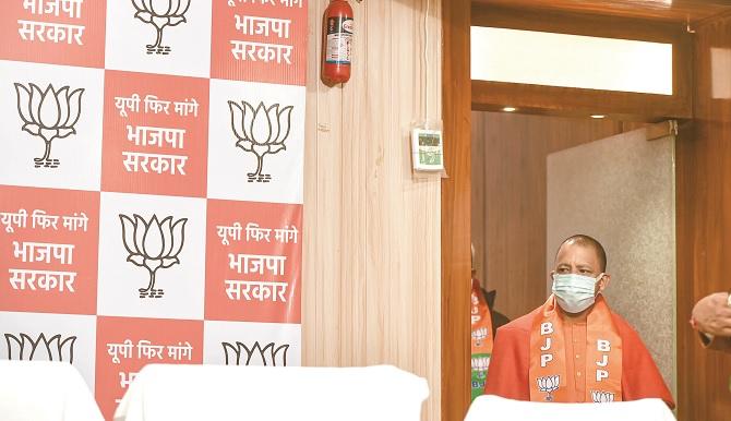 Yogi going to the press conference where new party slogans for UP elections are written.Picture:PTI