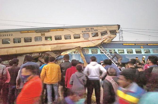 A crowd can be seen around the train that crashed. (PTI)