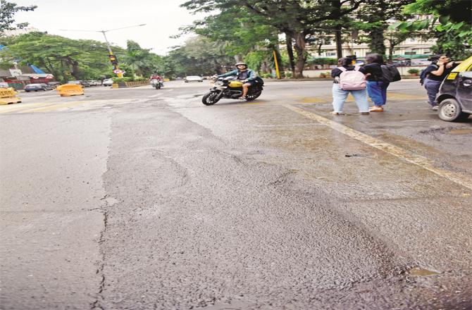 A road on Hill Road with potholes filled with angular technique.