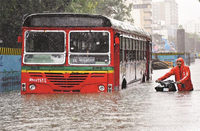 A bus submerged in rainwater can be seen (Photo: PTI)
