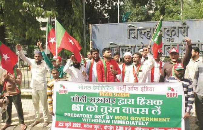 Protesters raise slogans against GST outside District Collector`s office.Picture:Inquilab