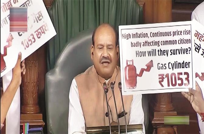 Waving a poster in front of Chief Opposition Speaker Om Birla in the Lok Sabha. (Photo: PTI)