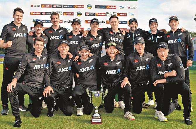 The New Zealand team can be seen with the trophy
