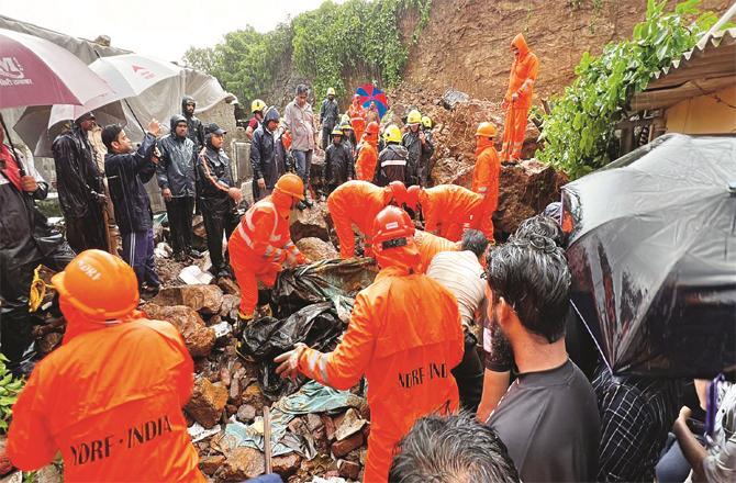 NDRF personnel can be seen busy removing debris