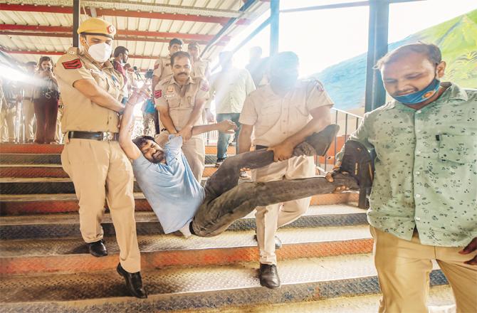 Police arrest a Congress worker at the Shivaji Bridge railway station in New Delhi. (Photo: PTI)