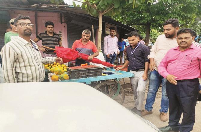 FDA and municipal officials take action against a fruit seller in an area of Bhiwandi.