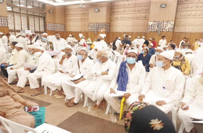 Pilgrims wait their turn for passports and tickets at Hajj House