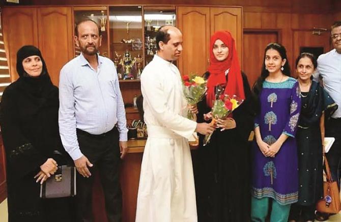 The principal of Elham College gives her a bouquet, along with her parents and others.Picture:INN