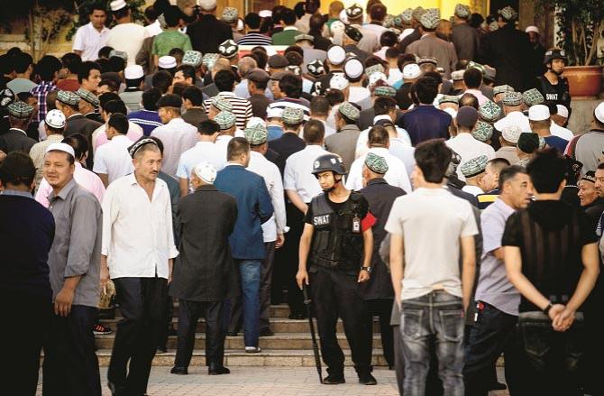 Uighur Muslims also observe Eid prayers under strict guard..Picture:INN