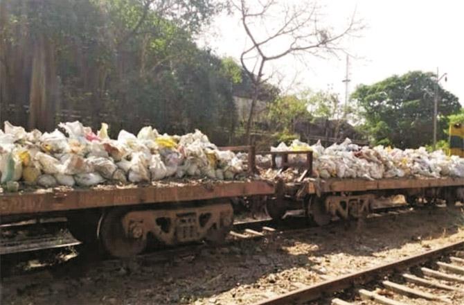 Garbage is being removed from near railway tracks.