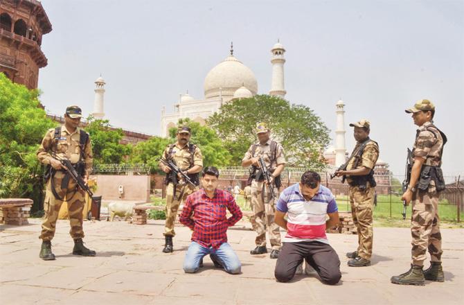 Security personnel practice in the back of the Taj Mahal. (PTI)