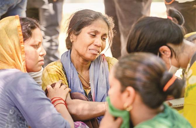Outside the hospital, grieving women are waiting for information on the missing persons in the accident. (PTI)