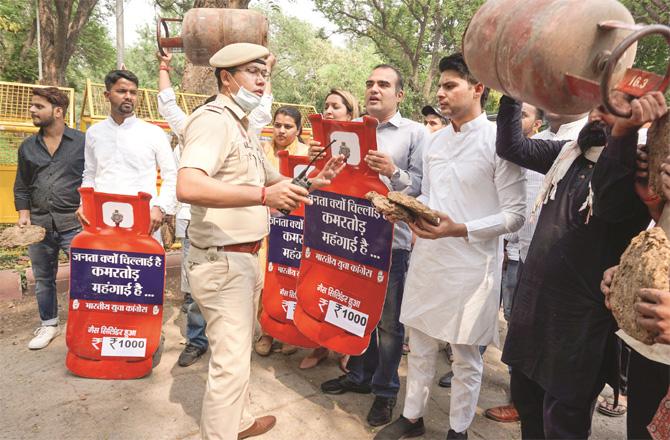 Youth Congress workers protest with cylinders in their hands outside the Petroleum Minister`s house. (Photo: PTI)