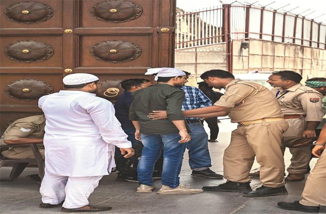 Police search worshipers at the entrance of Gyan Vapi Mosque